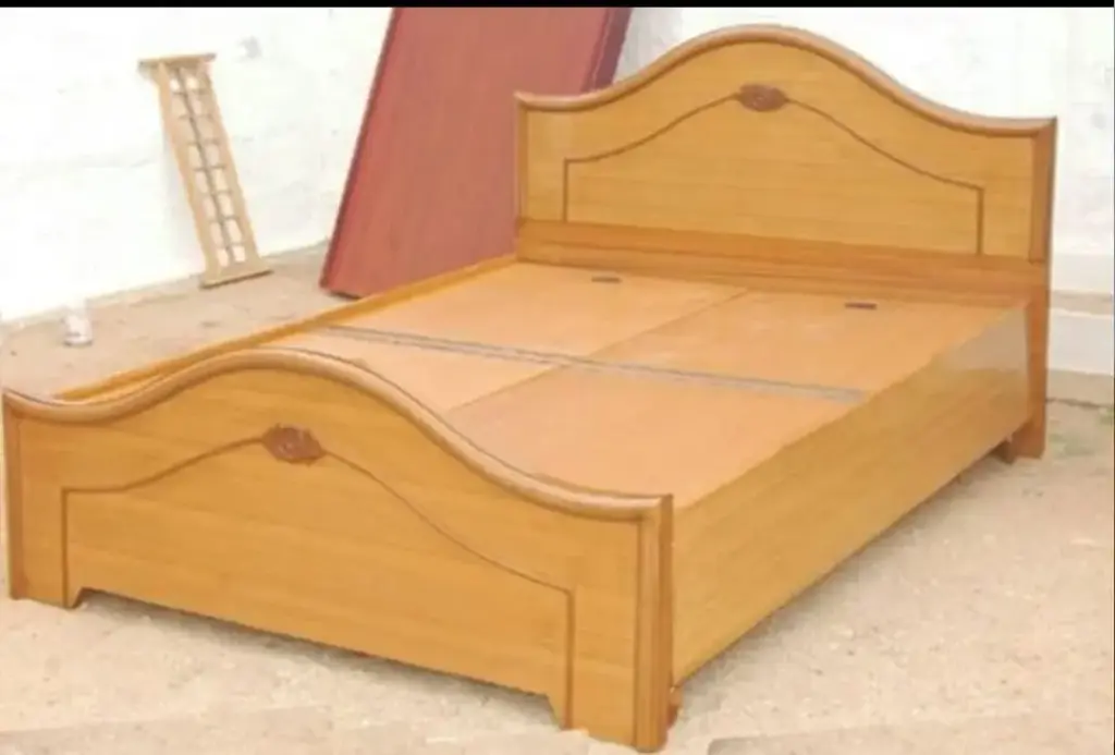Simple wooden bed with curved headboard